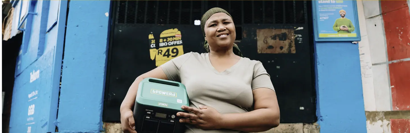 A bPOWERd customer holding a battery outside a shop