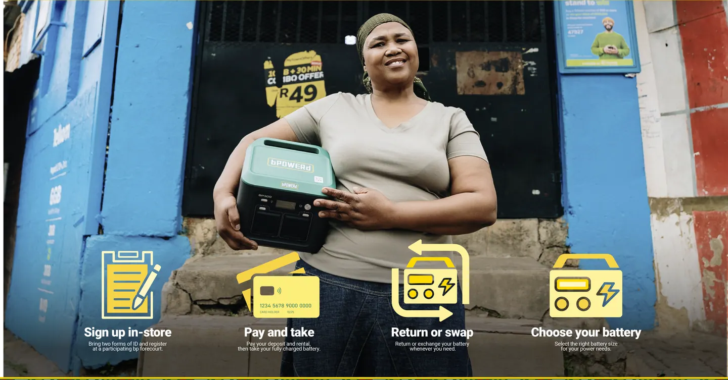 A bPOWERd customer holding a battery outside a shop